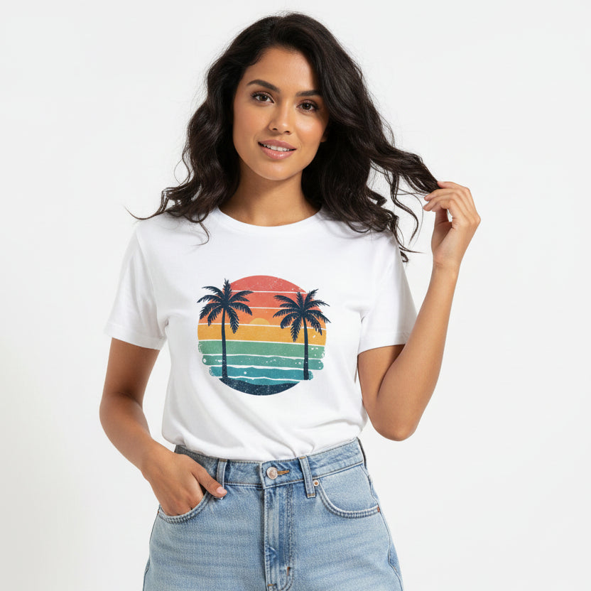 Woman wearing a white t-shirt with a colourful palm tree design on a plain background